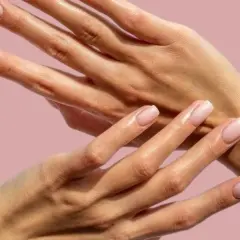 Två händer med ljusrosa naglar. Naglarna är välmanikyrerade, men nagelbanden är torra och behöver fukt.