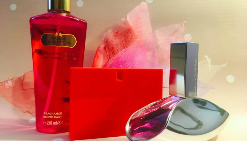 En röd flaska med "Mango Temptation" och en Calvin Klein "euphoria" parfym. Eau de toilette betyder en lättare parfym.